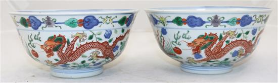 A pair of Chinese wucai dragon and phoenix bowls, Qianlong seal marks, late 19th/early 20th century, 18cm, small rim chips